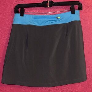 The North Face dark grey and turquoise “Eat my Dust” running skort. Sz large.